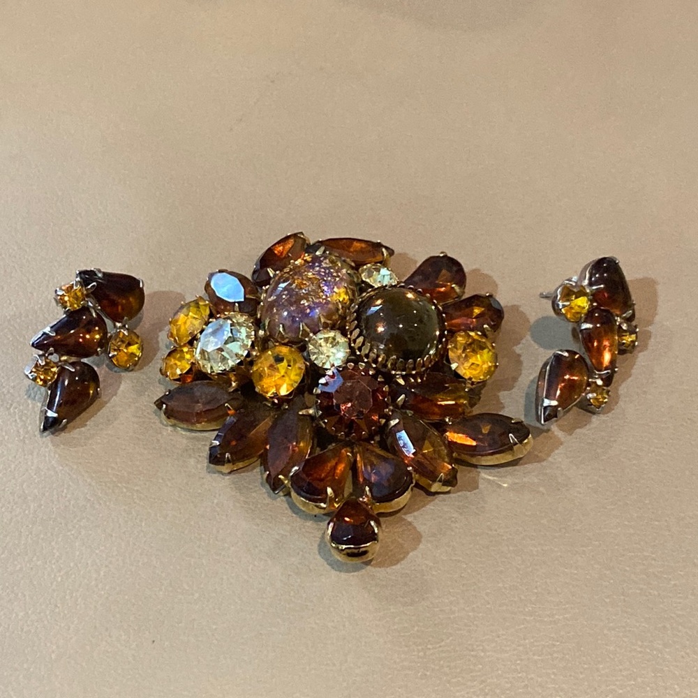Great fall color rhinestone brooch w “married” earrings. No maker’s mark.